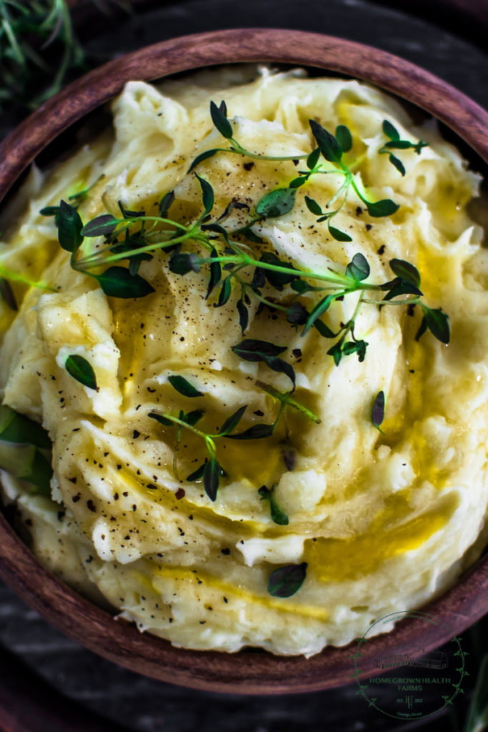 Holiday mashed potatoes topped with Zesty Mexican Blend microgreens from Homegrown Health Farms in a rustic wooden bowl.